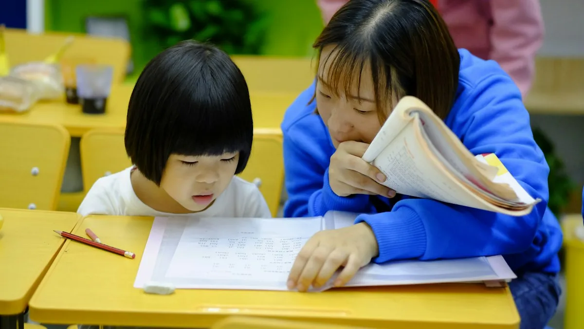 Teacher reading with a young student at a classroom desk