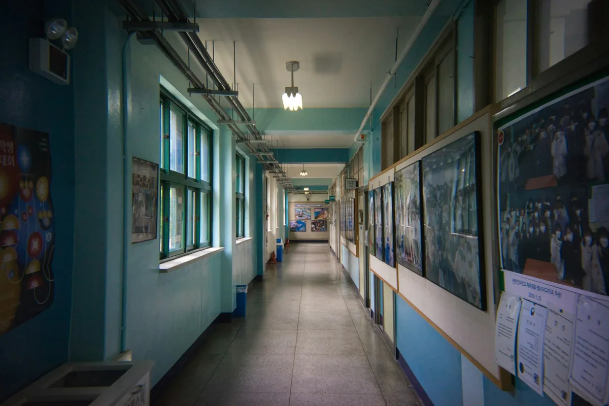 School hallway in Korea with student artwork and notices on the walls